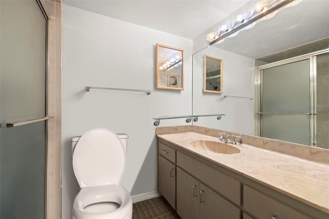 bathroom featuring vanity, toilet, tile patterned floors, and a shower with shower door