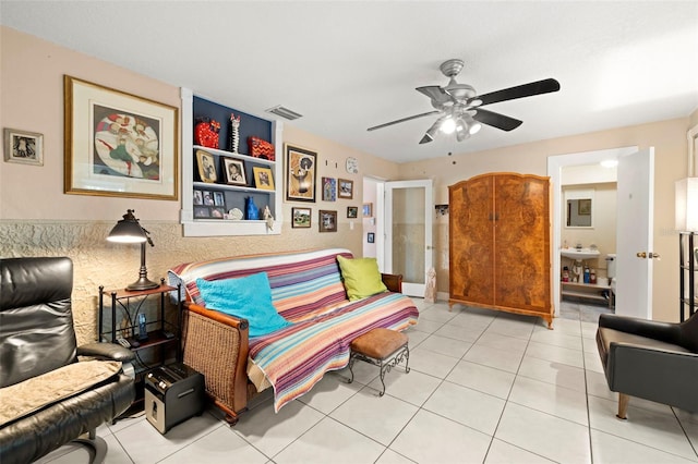 sitting room featuring light tile patterned flooring and ceiling fan