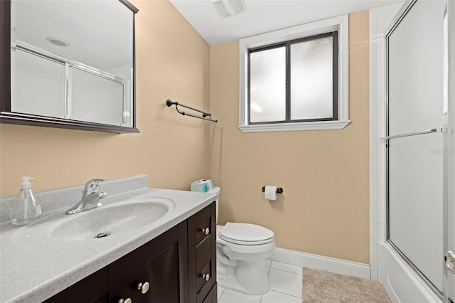 full bathroom with tile patterned flooring, vanity, bath / shower combo with glass door, and toilet