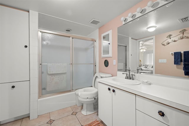 full bathroom featuring shower / bath combination with glass door, ceiling fan, vanity, tile patterned floors, and toilet