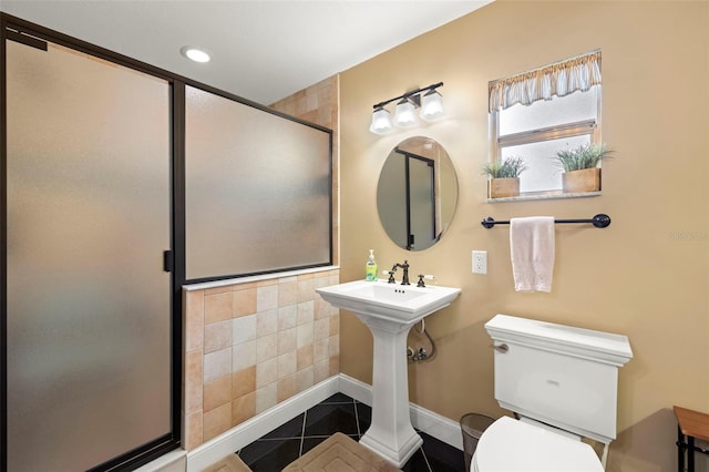 bathroom with tile patterned flooring, toilet, and walk in shower