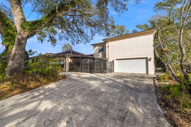 view of front of house featuring a garage and glass enclosure