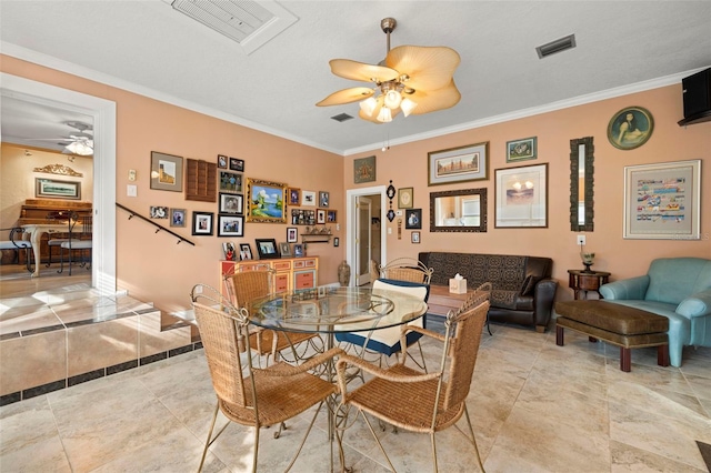 dining room with ceiling fan, ornamental molding, and visible vents