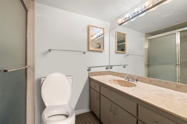 full bathroom featuring toilet, an enclosed shower, vanity, and tile patterned floors