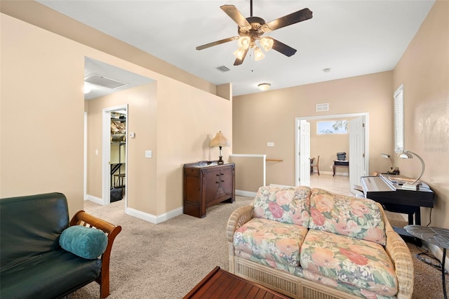 living area featuring a ceiling fan, light colored carpet, visible vents, and baseboards