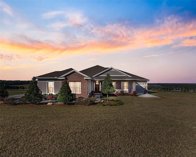 view of front of house featuring a garage and a lawn