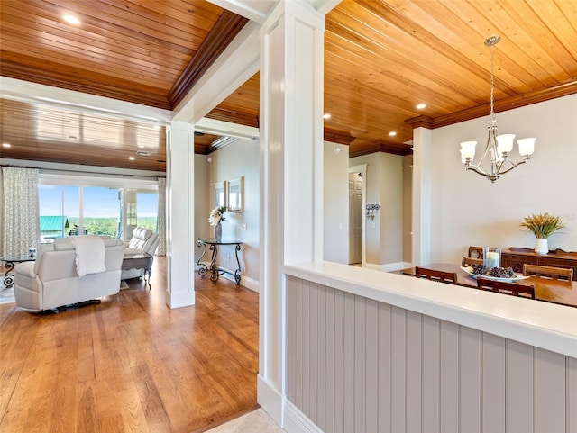 kitchen featuring pendant lighting, ornamental molding, and wooden ceiling