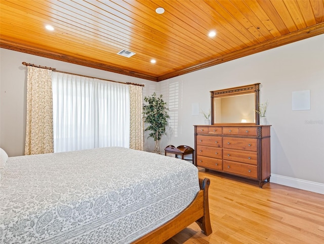 bedroom featuring ornamental molding, light hardwood / wood-style flooring, and wooden ceiling