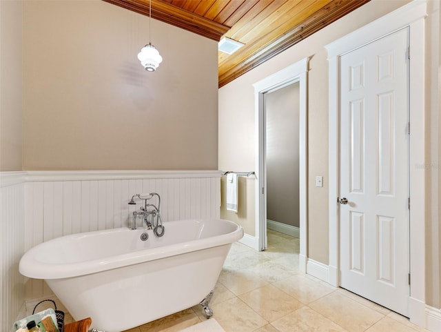 bathroom featuring tile patterned flooring, a bathtub, wood ceiling, and crown molding