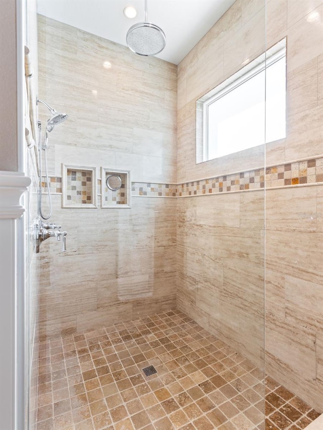 bathroom with a tile shower