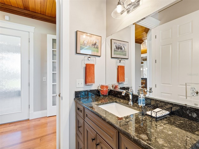 bathroom with hardwood / wood-style flooring, vanity, and wooden ceiling