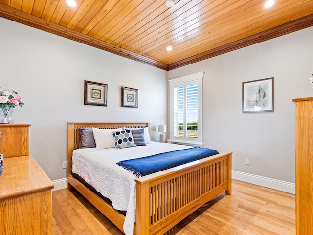 bedroom featuring ornamental molding, light hardwood / wood-style flooring, and wooden ceiling