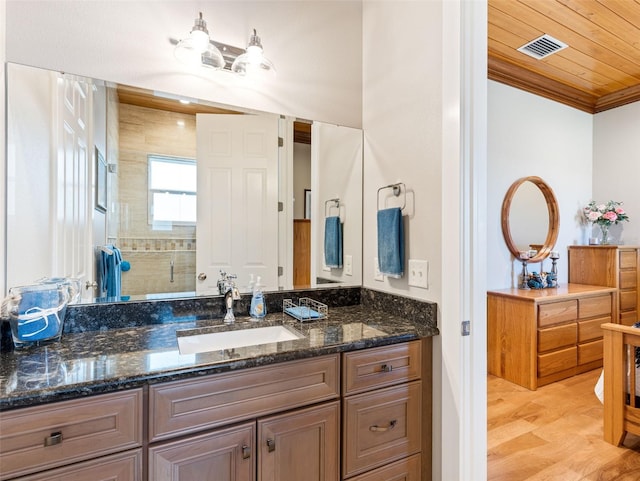 bathroom featuring hardwood / wood-style floors, vanity, wood ceiling, walk in shower, and crown molding