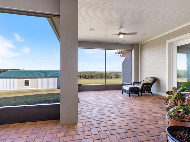 sunroom featuring ceiling fan