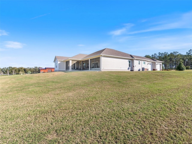 view of front of home with a front yard and a sunroom