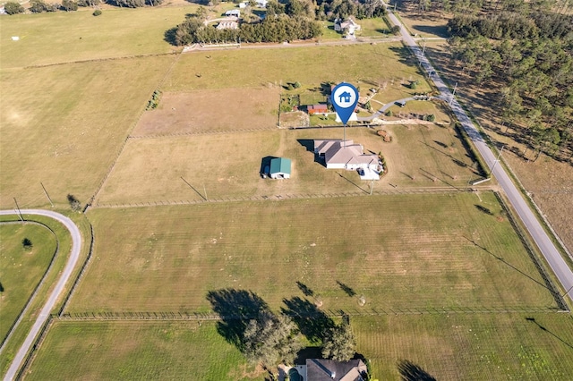 birds eye view of property with a rural view