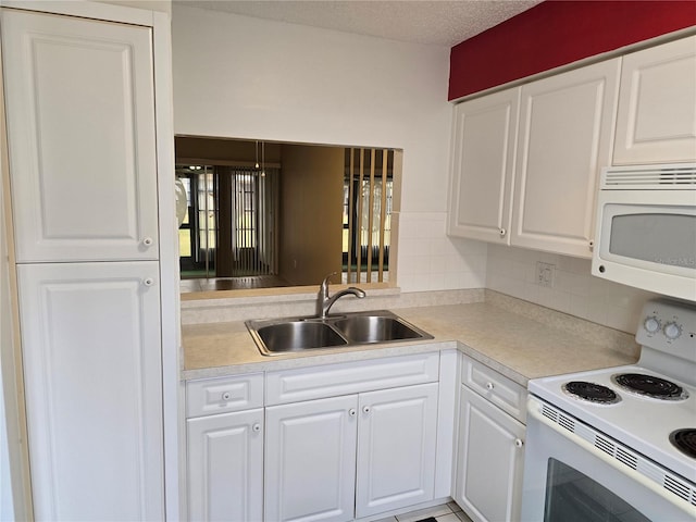 kitchen with white cabinetry, sink, white appliances, and backsplash