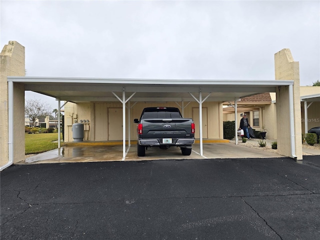 view of parking / parking lot featuring a carport