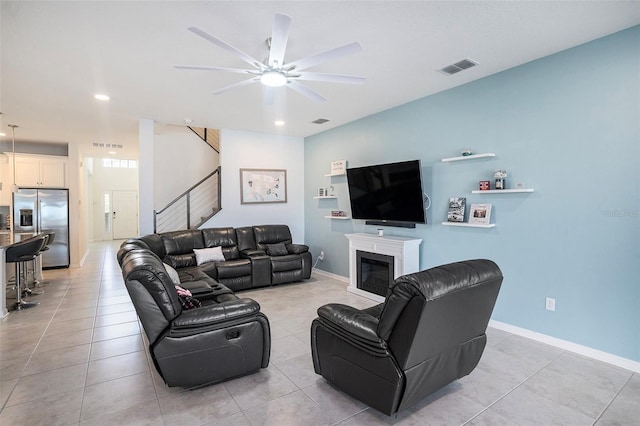 tiled living room featuring ceiling fan