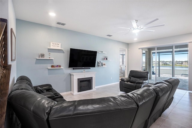 living room with ceiling fan and light tile patterned flooring