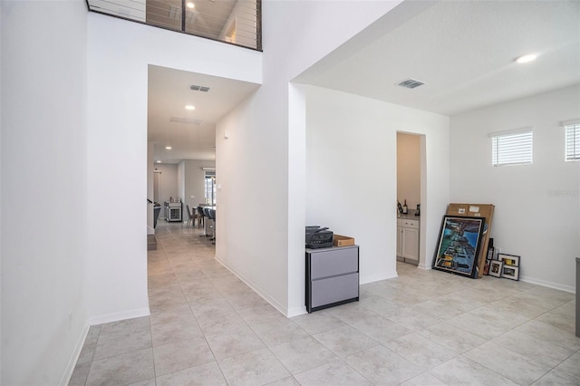 hallway with light tile patterned floors