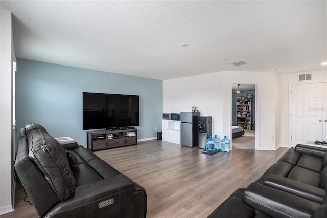 living room featuring hardwood / wood-style flooring and a textured ceiling