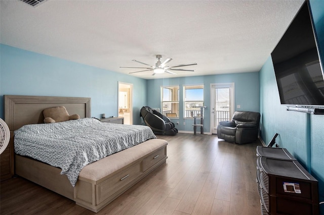 bedroom featuring ceiling fan, dark hardwood / wood-style flooring, and a textured ceiling