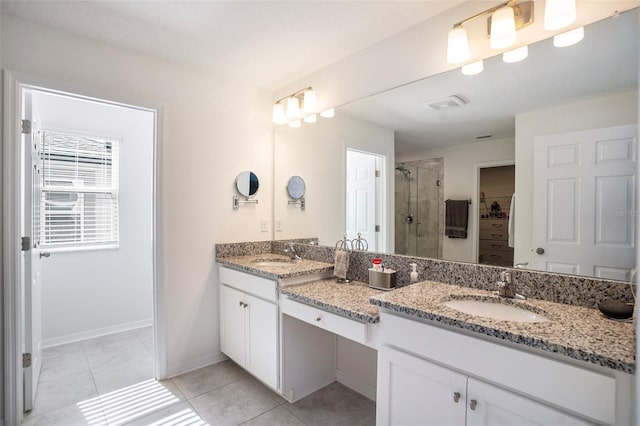 bathroom with vanity, an enclosed shower, and tile patterned floors