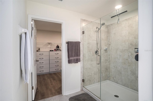 bathroom featuring walk in shower and hardwood / wood-style floors