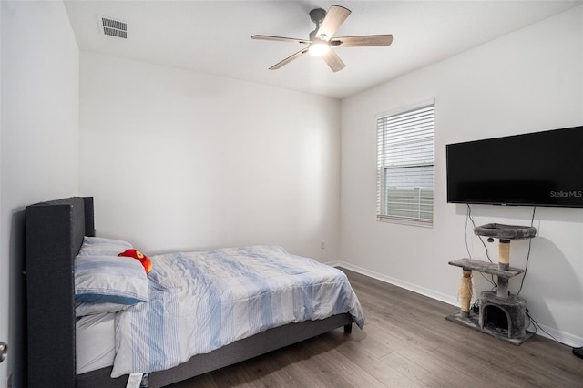 bedroom with dark hardwood / wood-style floors and ceiling fan