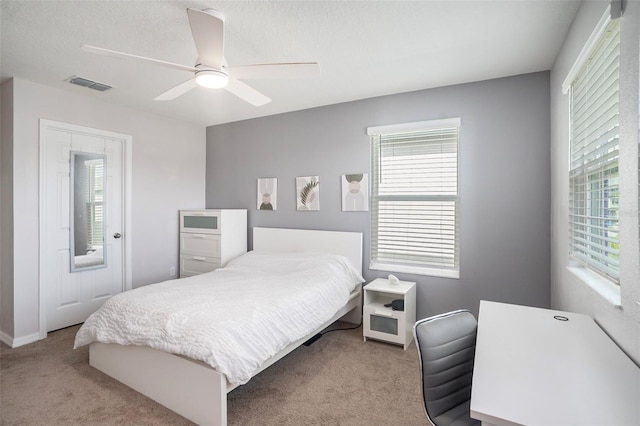 bedroom with ceiling fan and light carpet