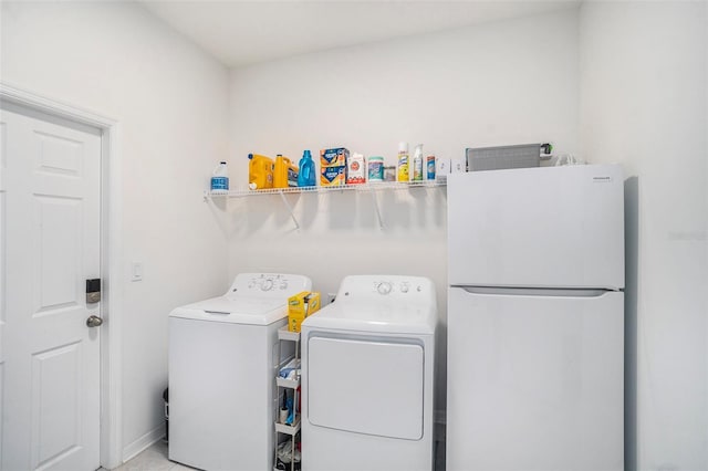 washroom with separate washer and dryer and light tile patterned floors