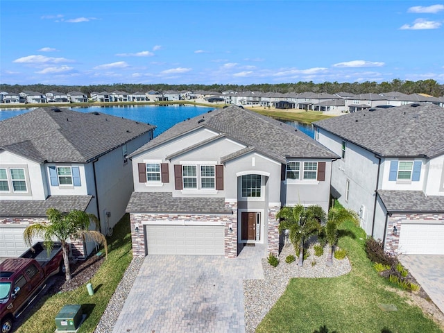 view of front of house featuring a garage and a water view