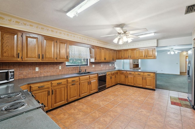 kitchen featuring light tile patterned flooring, sink, backsplash, ceiling fan, and stainless steel appliances