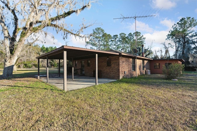 back of property with a patio and a lawn