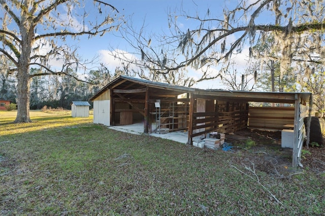 view of property exterior featuring an outdoor structure and a lawn