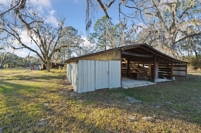 view of outbuilding featuring a lawn