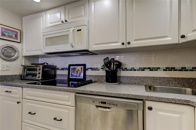 kitchen featuring white cabinetry, dishwasher, and tasteful backsplash