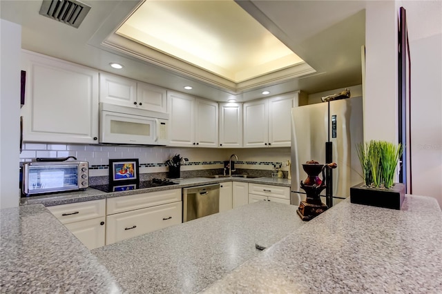 kitchen featuring white cabinetry, appliances with stainless steel finishes, and sink