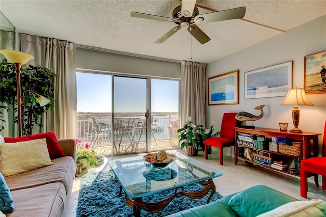 tiled living room featuring ceiling fan and a textured ceiling