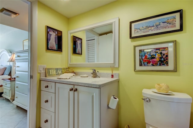 bathroom featuring vanity, toilet, and tile patterned flooring