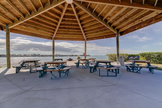 view of home's community with a gazebo, a water view, and a patio