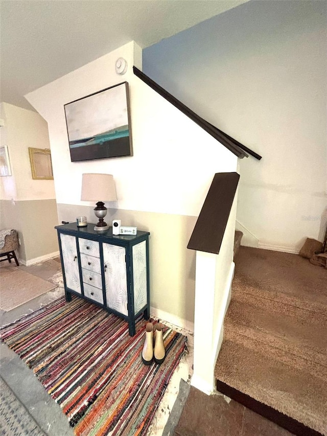 staircase with lofted ceiling