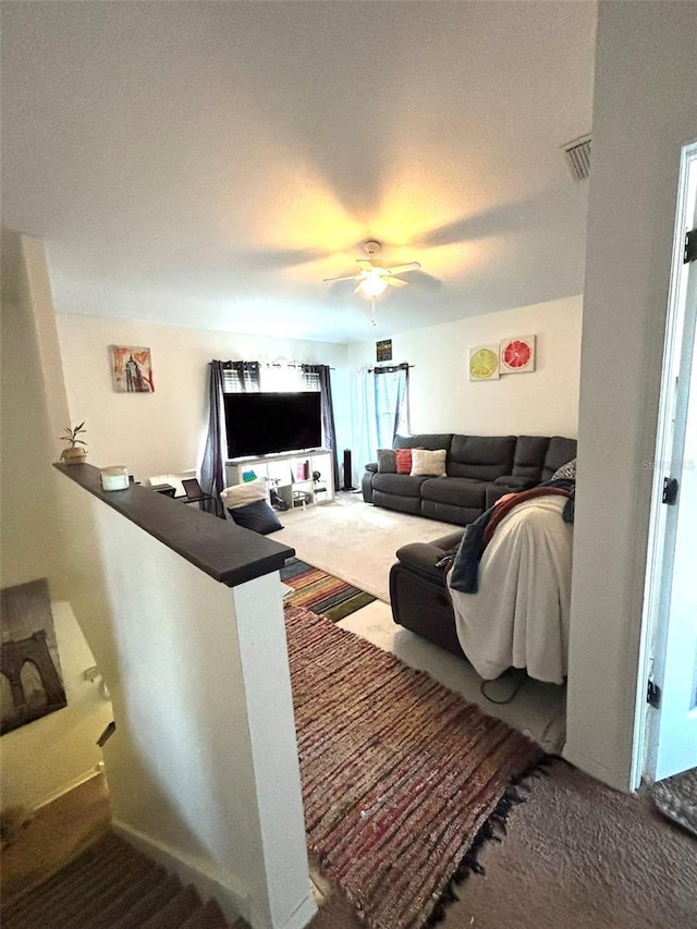 living room featuring carpet floors and ceiling fan