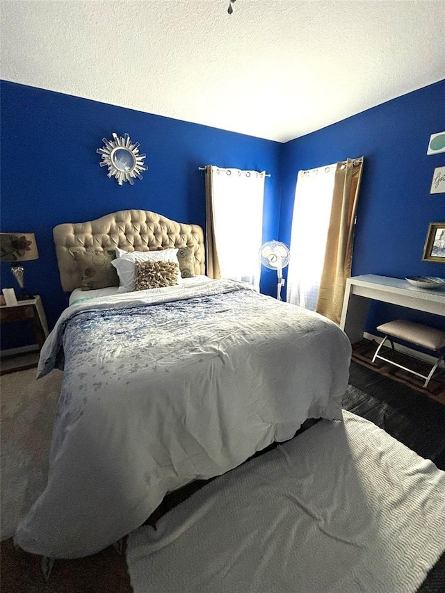 carpeted bedroom featuring a textured ceiling