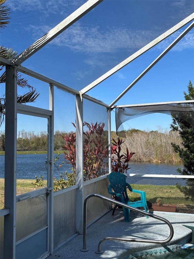 unfurnished sunroom with a water view