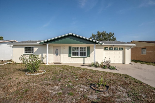 single story home with a garage and a front lawn