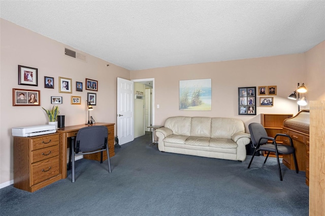 carpeted office space with a textured ceiling and visible vents