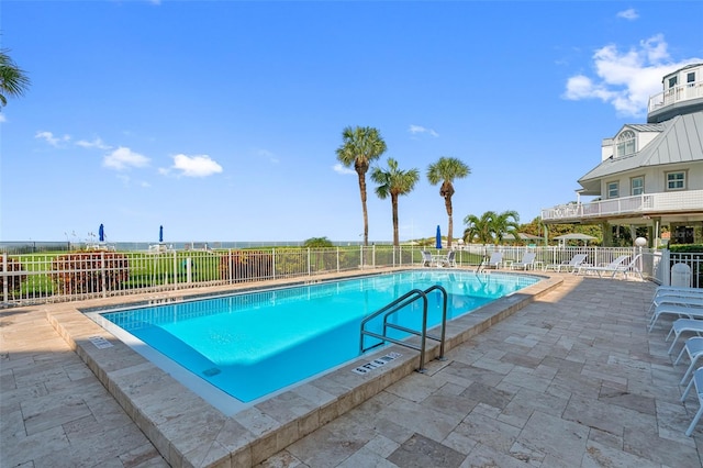 pool featuring a patio area and fence