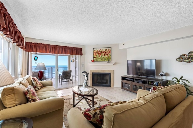 living area with light tile patterned floors, a fireplace, and a textured ceiling